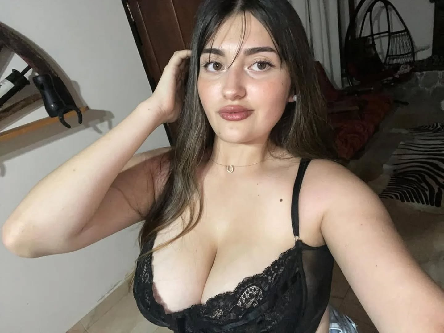 Woman in black lace top indoors.