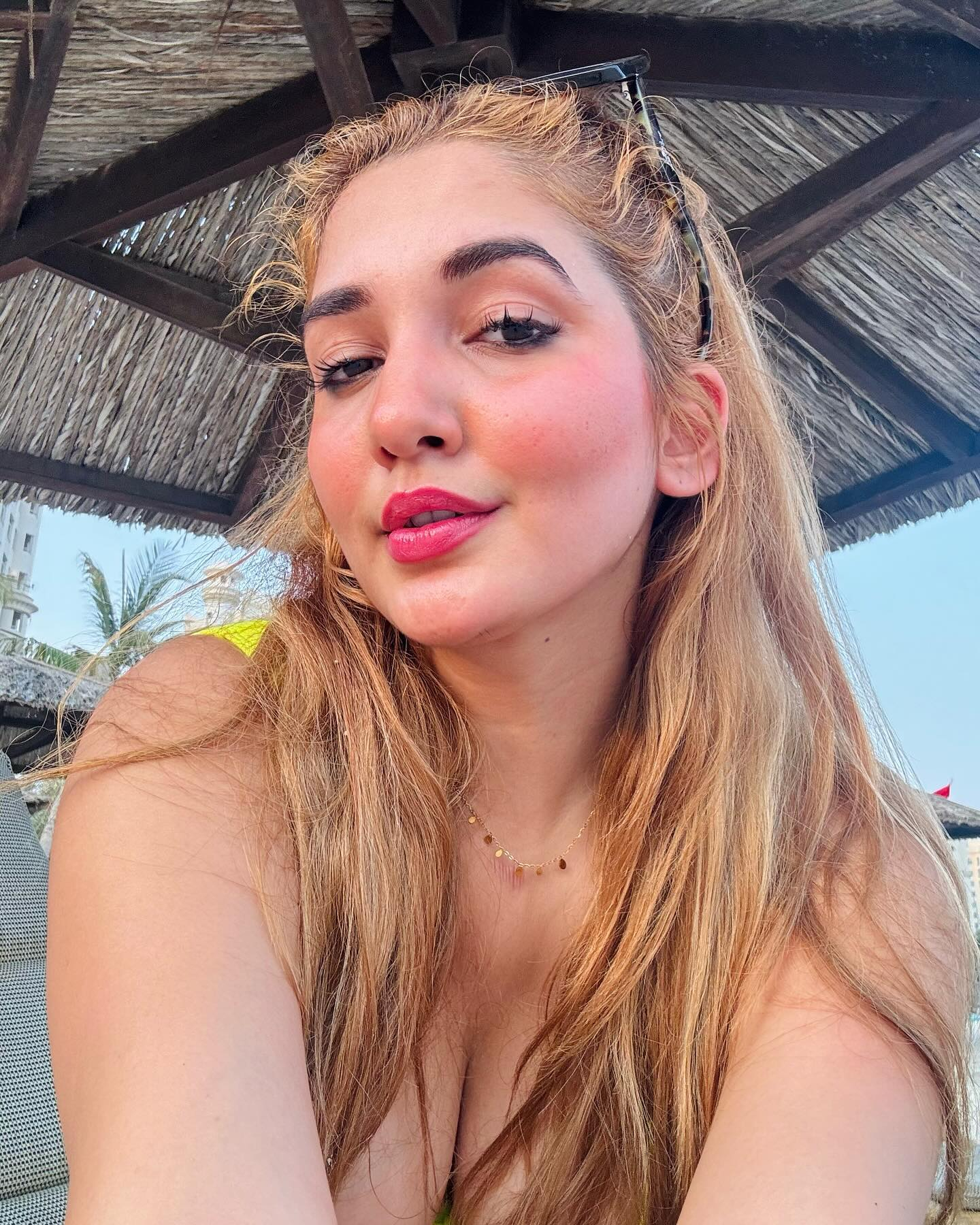 Blonde woman close-up with pink lips.