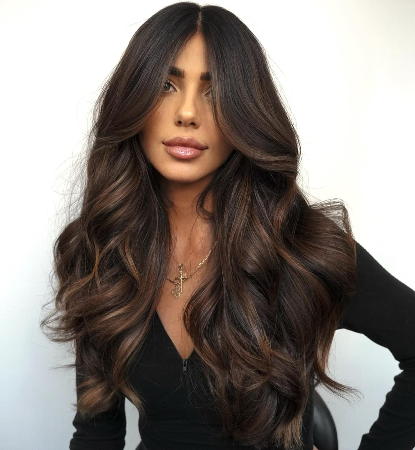 Brunette woman with wavy hair.