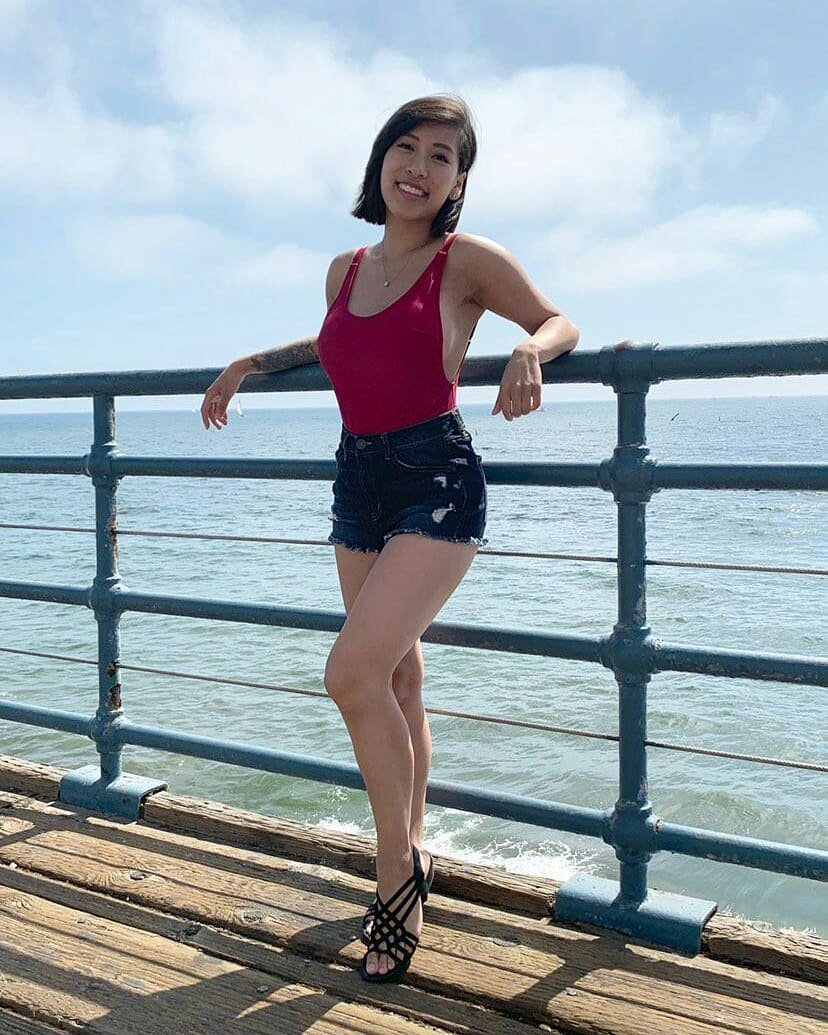 Woman in a red swimsuit on a pier.