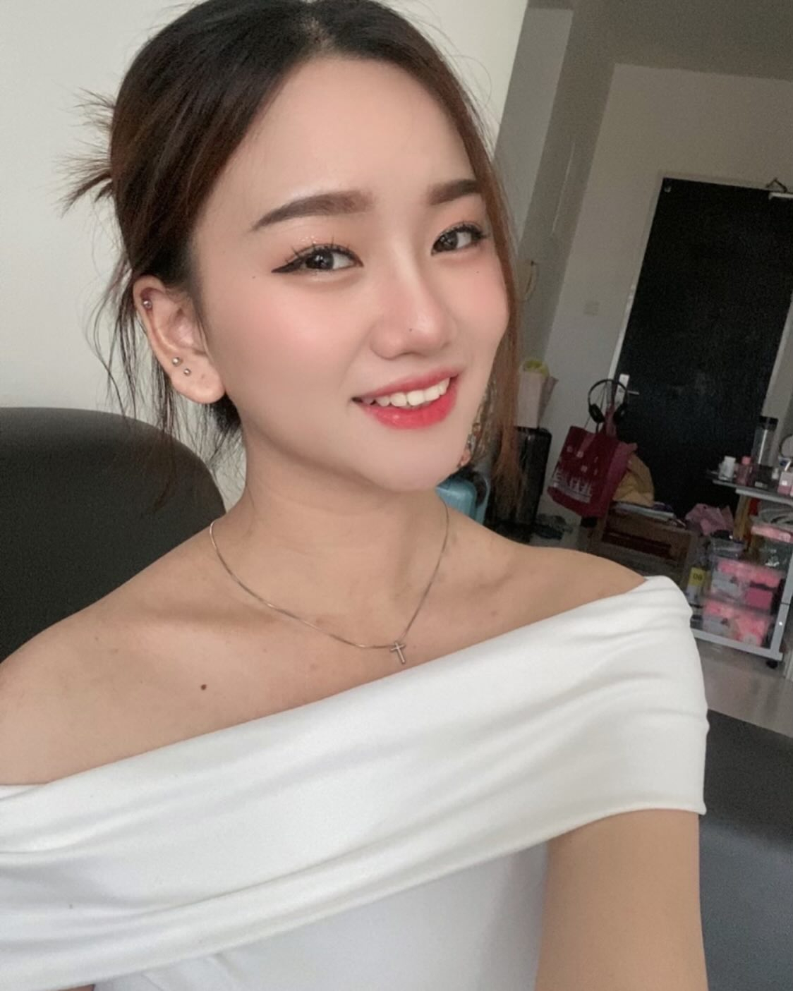 Close-up selfie of smiling woman.