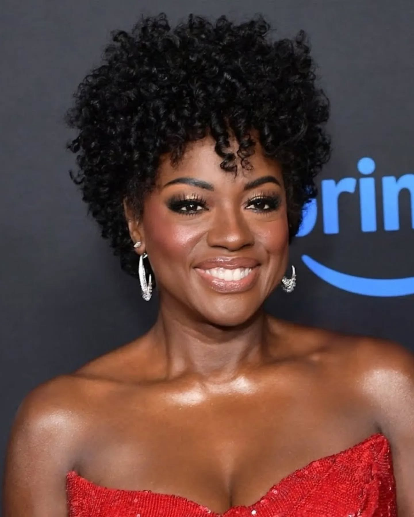 Viola Davis smiles in red dress.