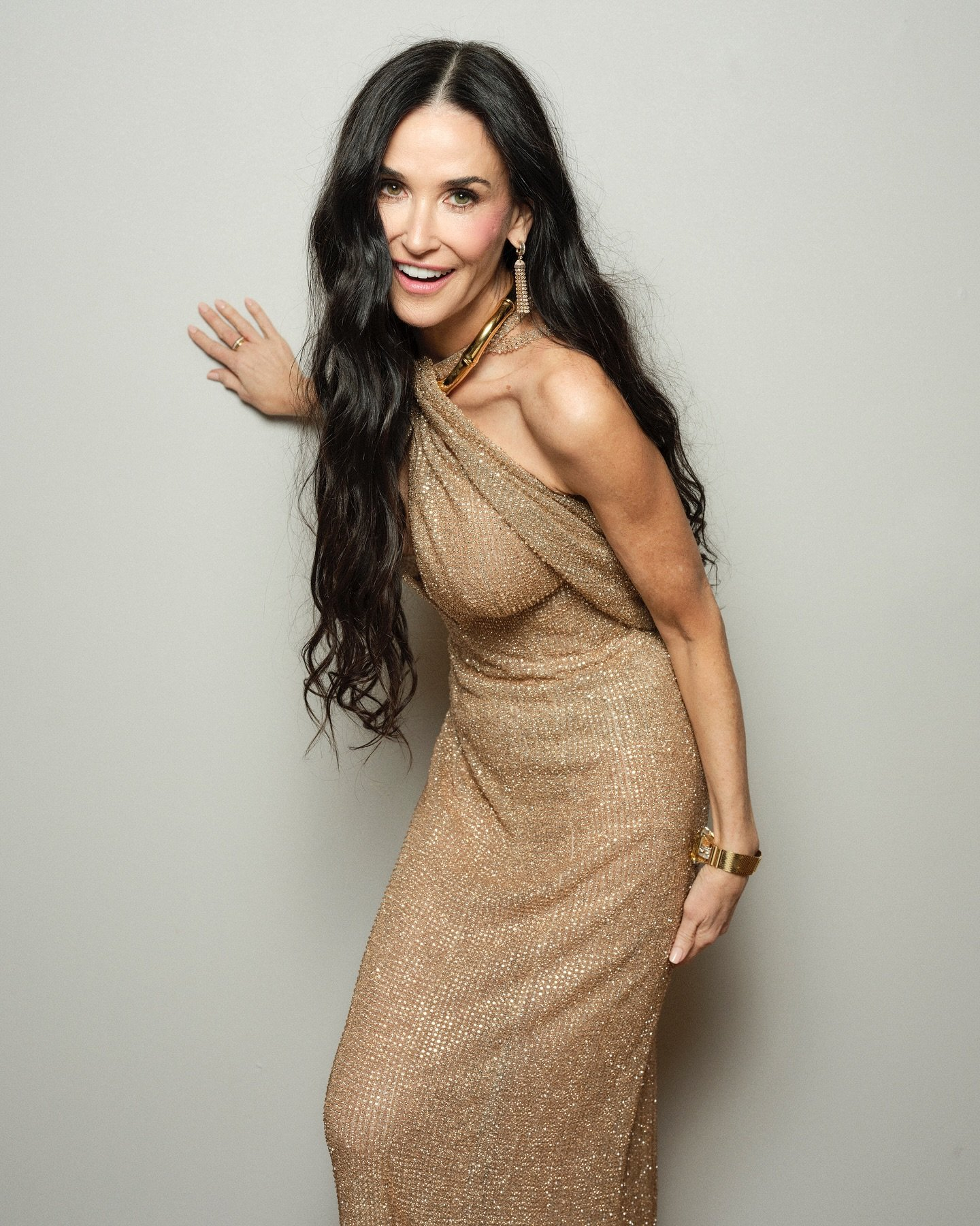Demi Moore in gold sparkling dress.